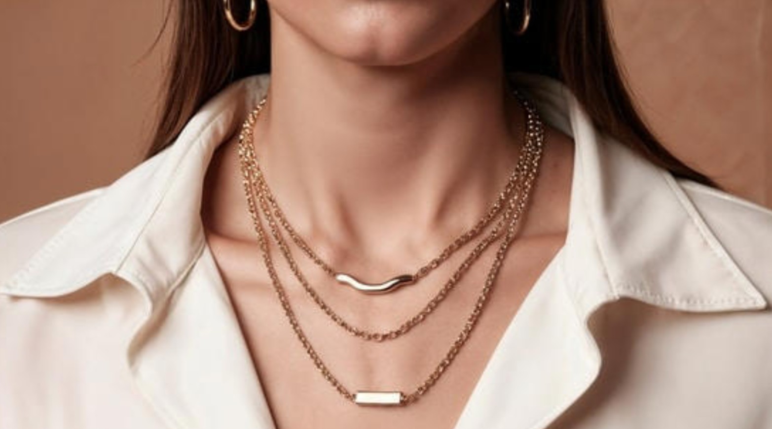 Elegant layered gold and silver necklaces styled with modern fashion outfits
