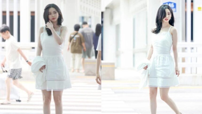 aespa member Karina wearing a white dress at the airport before changing into a casual travel look