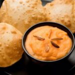Assorted regional Indian pooris including Bedmi Puri, Luchi, Palak Puri, Masala Puri, and Mangalore Buns served with traditional accompaniments.
