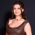 Anne Hathaway attends a red carpet event while discussing her pregnancy journey